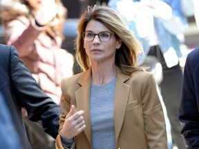 In this file photo taken on April 03, 2019, actress Lori Loughlin arrives to face charges for allegedly conspiring to commit mail fraud and other charges in the college admissions scandal at the John Joseph Moakley US Courthouse in Boston.