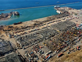 An aerial view shows the massive damage done to Beirut port's grain silos, centre, and the area around it on August 5, 2020, one day after a mega-blast tore through the harbour in the heart of the Lebanese capital.