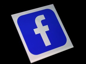 In this file photo taken on March 25, 2020 in this photo illustration a Facebook App logo is displayed on a smartphone in Arlington, Virginia.