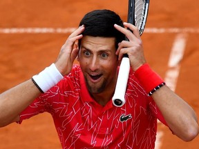 In this file photo Serbia's Novak Djokovic reacts as he takes part in tennis match during a charity exhibition hosted by him, in Belgrade on June 12, 2020.