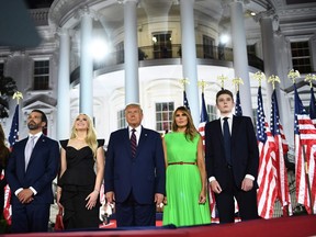 From right, Barron Trump, US First Lady Melania Trump, US President Donald Trump, Tiffany Trump, Donald Trump Jr. and Kimberly Guilfoyle watch fireworks at the conclusion of the final day of the Republican National Convention from the South Lawn of the White House on August 27, 2020 in Washington, DC.