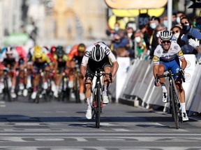 Team Deceuninck rider France's Julian Alaphilippe (R) celebrates as he crosses the finish line ahead of Team Sunweb rider Switzerland's Marc Hirschi (L) during the 2nd stage of the 107th edition of the Tour de France cycling race, 187 km between Nice and Nice, on August 30, 2020.
