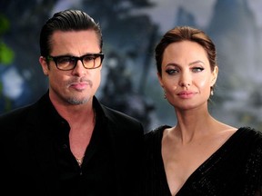 This file photo taken on May 8, 2014 shows US actress Angelina Jolie (R) along with her husband US actor Brad Pitt as they arrive for the premiere of the film "Maleficent" at Kensington Palace in London.