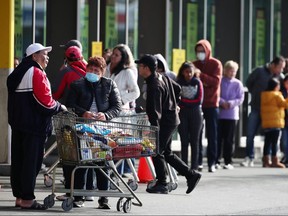People queue outside a supermarket on August 12, 2020 in Auckland, New Zealand.
