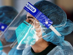 Medical personnel is pictured wearing a BYD Care N95 particulate respirator mask and a face shield while working at a pop-up testing centre in Sydney, Australia, July 30, 2020.
