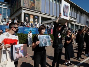 Participants hold pictures of people, injured in recent opposition rallies following the presidential election, during a protest against police violence in Minsk, Belarus August 15, 2020.