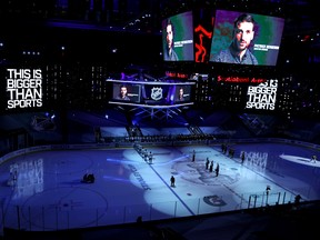 As the Tampa Bay Lightning and Boston Bruins look on, a pre-recorded message from Patrice Bergeron is played, as the NHL addresses racism, prior to Game 4 of the Eastern Conference on Saturday at Scotiabank Arena in Toronto.