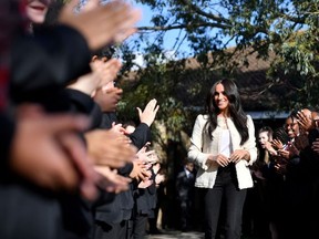 Britain's Meghan, Duchess of Sussex, smiles as she is welcomed by students to visit the Robert Clack School in Essex, Britain March 6, 2020, in support of International Women's Day. Picture taken March 6, 2020.