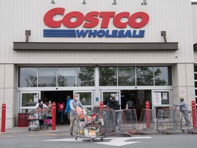 Shoppers walk out with full carts from a Costco store in Washington on May 5, 2020.