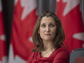 Deputy Prime Minister and Minister of Intergovernmental Affairs Chrystia Freeland looks at a projected graphic during a news conference in Ottawa, Monday April 6, 2020.