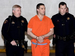 Convicted murderer Scott Peterson is escorted by San Mateo County Sheriff deputies as he is walked from the jail to an awaiting van, March 17, 2005 in Redwood City, California.