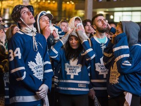 Leafs' fans face the reality the Toronto Maple Leafs will lose to the Boston Bruins towards the end of Game 7, during the First Round playoffs, as they watch on the big screens outside of Scotiabank Arena on Bremner Blvd in Toronto, Ont. on Tuesday April 23, 2019. Ernest Doroszuk/Toronto Sun/Postmedia