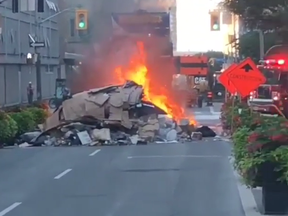 Garbage aboard a dump truck is seen on fire at Adelaide and Simcoe Sts. Monday, Aug. 17, 2020.