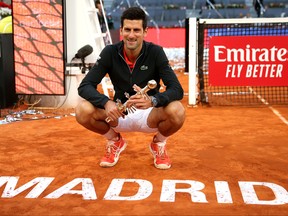 Last year's Madrid Open winner, Novak Djokovic of Serbia celebrates victory as he poses with his trophy following the men's singles final against Stefano Tsitsipas of Greece on May 12, 2019 in Madrid, Spain.