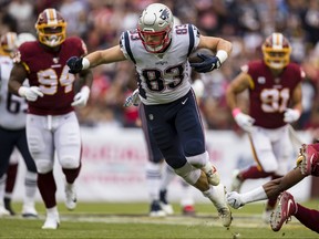 Matt LaCosse of the New England Patriots leaps to avoid a tackle by Montae Nicholson of the Washington Redskins during the first half at FedExField on October 6, 2019 in Landover, Maryland.