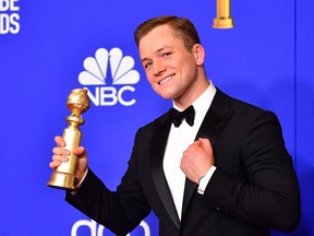 Actor Taron Egerton poses in the press room with the award for Best Performance by an Actor in a Motion Picture - Musical or Comedy during the 77th annual Golden Globe Awards on Jan. 5, 2020, at The Beverly Hilton hotel in Beverly Hills, Calif.