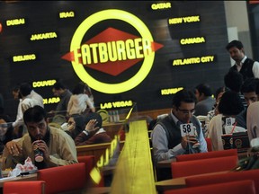 In this picture taken on Jan. 10, 2013, Pakistani customers eat at a Fatburger outlet in Karachi.