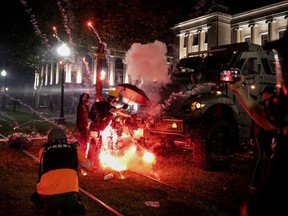 An incendiary device goes off in front of a Kenosha Country Sheriff Vehicle as demonstrators take part in a protest following the police shooting of Jacob Blake, a Black man, in Kenosha, Wisconsin, U.S. August 25, 2020.