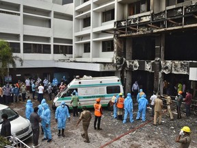 Rescue workers look for survivors after a fire broke out in a hotel that was being used as a coronavirus disease (COVID-19) facility in Vijayawada, in the southern state of Andhra Pradesh, India, August 9, 2020.