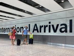 Passengers from international flights arrive at Heathrow Airport in London July 29, 2020.