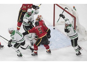 Calgary Flames goalie Cam Talbot (No. 39) and teammate Mark Giordano react as the Dallas Stars' Alexander Radulov (No. 47), Joe Pavelski (No. 16) and Tyler Seguin (No. 91) celebrate a goal during third-period NHL Western Conference Stanley Cup playoff action in Edmonton on Sunday, August 16, 2020.