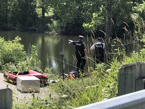 York Regional Police officers search for a missing man who was swept into a Richmond Hill pond.