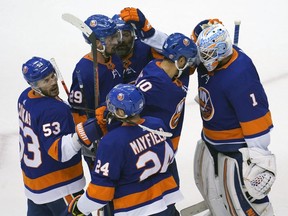 New York Islanders goaltender Thomas Greiss (1) celebrates with teammates beating the Philadelphia Flyers Sunday at Scotiabank Arena.
