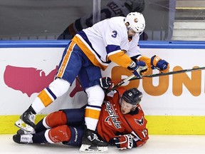 Jakub Vrana of the Washington Capitals is checked by Adam Pelech of the New York Islanders during Game 2 of the Eastern Conference first round at Scotiabank Arena on August 14, 2020 in Toronto.