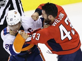 Tom Wilson of the Washington Capitals and Anders Lee of the New York Islanders fight at Scotiabank Arena on August 12, 2020 in Toronto.