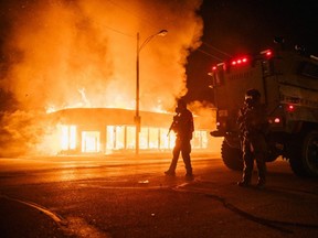 A police armoured vehicle patrols an intersection on Monday, Aug. 24, 2020 in Kenosha, Wisconsin. This is the second night of rioting after the shooting of Jacob Blake, 29, on Aug. 23.