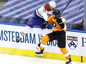 Montreal’s Jesperi Kotkaniemi collides with Philadelphia’s Shayne Gostisbehere in Game 2 of their playoff series yesterday. The Canadiens won the game 5-0. Getty images