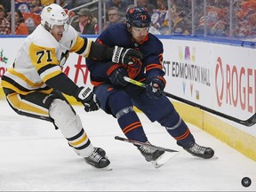 Pittsburgh Penguins forward Evgeni Malkin (71) and Edmonton Oilers defencemen Oscar Klefbom (77) battle for the puck at Rogers Place.