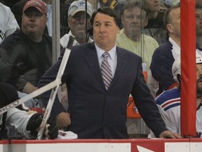 TV commentator Mike Milbury works between the benches in a game between the Penguins and Rangers during the Stanley Cup Playoffs in Pittsburgh, May 4, 2008.