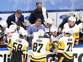 Head coach Mike Sullivan and assistant coach Mark Recchi of the Pittsburgh Penguins talk with his players during a time out late in the third period against the Montreal Canadiens in Game Four of the Eastern Conference Qualification Round prior to the 2020 NHL Stanley Cup Playoffs at Scotiabank Arena on Aug. 7, 2020 in Toronto.