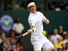 Japan's Kei Nishikori in action during his quarterfinal match against Switzerland's Roger Federer at Wimbledon.