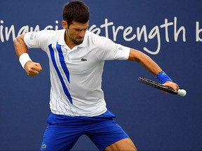 Novak Djokovic reacts against Milos Raonic during the Western and Southern Open Saturday at the USTA Billie Jean King National Tennis Center.