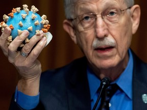 Dr Francis Collins, director of the National Institutes of Health (NIH), holds up a model of SARS-CoV-2, known as the novel coronavirus,  during a U.S. Senate Appropriations Subcommittee Hearing on the plan to research, manufacture and distribute a coronavirus vaccine, known as Operation Warp Speed on Capitol Hill in Washington, D.C, July 2, 2020.