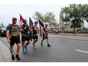 Four Canadian Forces veterans walk down Wellington Street past Parliament Hill on Sunday Aug 9, 2020. The veterans took part in a 175 kilometre walk from CFB Petawawa to the National War Memorial in Ottawa, to support Wounded Warriors Canada. The organization provides care and support to wounded veterans and first responders who suffer from occupational stress injuries such as PTSD. The group raised over $30,000.