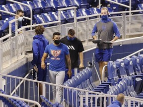 Pete Alonso and Ali Sanchez of the New York Mets walk to the clubhouse after the game between the Mets and the Miami Marlins was postponed due to a member of the Mets organization testing positive for COVID-19 at Marlins Park on Thursday, Aug. 20, 2020 in Miami.