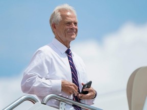 White House economic adviser Peter Navarro looks out from the steps of Air Force One as he waits to depart with U.S. President Donald Trump for travel to Ohio and New Jersey at Joint Base Andrews, Maryland, Aug. 6, 2020.