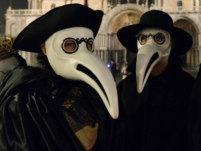 Masked revellers take part in the "Plague Doctors Procession" on Saint Mark Square in Venice on February 25, 2020.