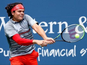 Milos Raonic returns a shot to Stefanos Tsitsipas in their semifinal match during the Western and Southern Open at the USTA Billie Jean King National Tennis Center on August 28, 2020 in New York.
