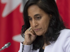 Public Services and Procurement Minister Anita Anand listens to a translation aid during a news conference, Tuesday, July 21, 2020 in Ottawa.