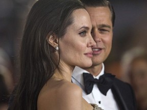 Director and cast member Angelina Jolie and her husband and co-star Brad Pitt pose at the premiere of "By the Sea" during the opening night of AFI FEST 2015 in Hollywood, California November 5, 2015.