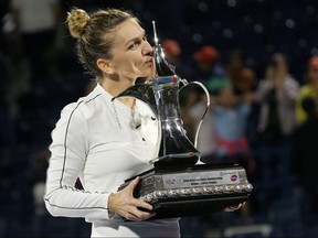 Simona Halep poses with the trophy after winning the Dubai Tennis Championships final against Elena Rybakina February 22, 2020.