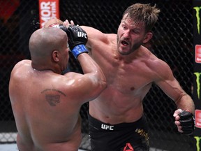 In this handout image provided by UFC, Stipe Miocic punches Daniel Cormier in their heavyweight championship bout during UFC 252 at UFC APEX on August 15, 2020 in Las Vegas.