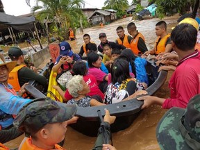 Soldiers evacuate villagers affected by heavy rain at Muang district in Loei province, Thailand, August 2, 2020.