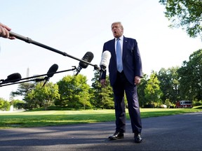 President Donald Trump talks to reporters as he departs for the Camp David presidential retreat from the South Lawn of the White House in Washington May 15, 2020.