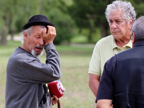 Joe Miskokomon, one of four deputy grand council chiefs of the Anishinabek Nation, watches as Pierre George wipes away a tear during the 25th anniversary of the death of his younger brother Dudley George on Sunday Sept. 6, 2020 in Lambton Shores, Ont.