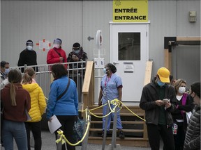 Nurse (centre) looks around at surrounding patients waiting to get tested at the Jewish General Hospital on Tuesday September 15, 2020.